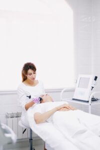 Beautician performing laser skin treatment